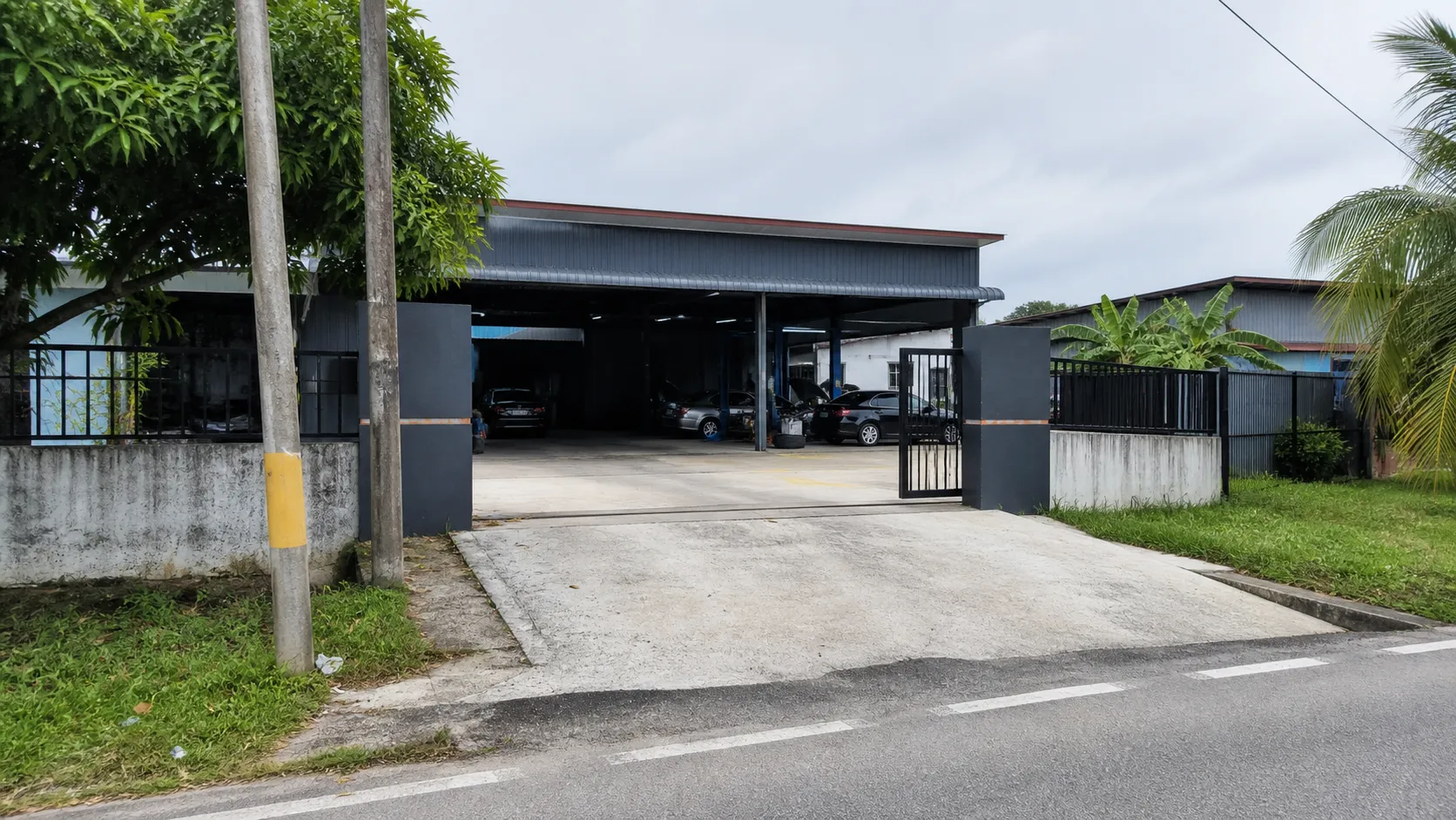 Workshop scene showing street approach to an independent auto workshop